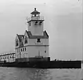 Kewaunee Lighthouse in 1965 at the completion of the pier widening and capping project. The dual diaphones are visible as well as the Fresnel Lens.