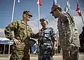 U.S. Army and Marine Corps officials conversing with a People's Liberation Army senior colonel during Khaan Quest 2015