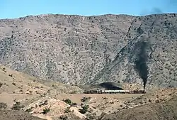The Khyber Railway. With a Pakistan Railways HGS 2-8-0 at front and rear a charter train climbs the Khyber Pass through a series of zig-zags to gain height
