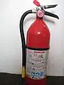 A typical dry chemical extinguisher containing 5 lb (2.3 kg) of monoammonium phosphate dry chemical