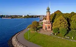 A brick tower overlooking water