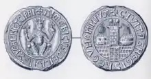 Photo of two ancient silver circular seals of Aimery, with non-Latin words framing the outer part of the seals.