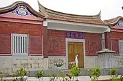 The facade of a mock building depicting a traditional ancestral home found on Kinmen. It is located across the roadway in front of Kinmen Airport