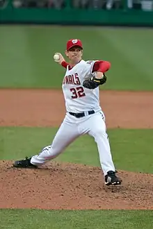 Kip wells in his wind-up, preparing to throw a pitch for the Washington Nationals, wearing uniform number 32.