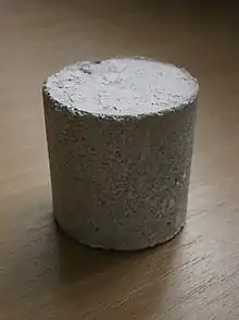 A cylinder of grey gypsum concrete
