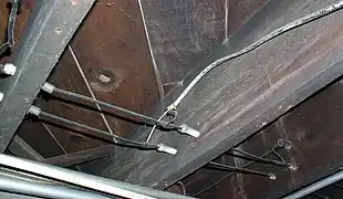 Wiring running through tubes, and turning a corner supported by a knob.  Notice the direct splice with more modern (1950s-era) non-metallic sheathed cable.  This type of connection is forbidden by the National Electrical Code, and a junction box should have been used.