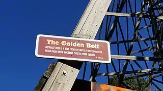A plaque commemorating the "golden bolt," a bolt salvaged from the original Mister Twister and installed into the structure of the swoop curve