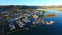 An aerial view of Knysna and its waterfront area, with the lagoon visible in the background to the right