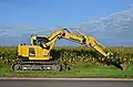 Komatsu PC138 US on a roadside in France