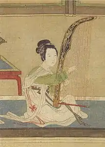 sitting Asian woman in fine dress plays