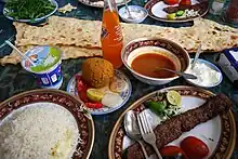 A table of some of Tabriz traditional foods (köfte and syrup with sangak and Bonab Kababi with rice)