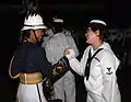 A musician of the Pacific Fleet Band with a musician of the Tonga Royal Corps of Musicians at the Kuala Lumpur International Tattoo.