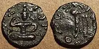 Coin of Kujula Kadphises.Obv Kujula seated cross legged facing, Kharoshti legend: Kuyula Kadaphasa Kushanasa.Rev Zeus on the reverse, Greek legend: ΚΟΖΟΛΑ XOPANOY ZAOOY.