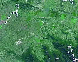 Satellite image of a green valley dominated by farming and agriculture