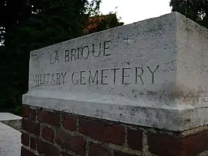 Stone at entrance to La Brique Military Commonwealth War Graves Commission cemetery