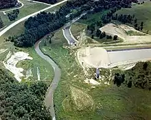 An aerial view of the incomplete Kickapoo River Dam, with the river in the center