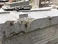 Shrapnel holes on a headstone.