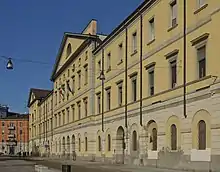 Photograph of the façade of an ochre-coloured building.