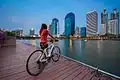 A woman with a bicycle at Benchakitti Park in Bangkok