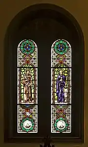 Stained glass windows depicting Saint Diego de Alcalá and Blessed Ignacio de Azevedo