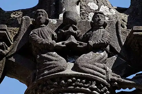 Two angels have collected Jesus' blood in a chalice. Part of the Lampaul-Guimiliau calvary