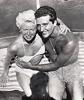 Woman and man in bathing suits, embracing