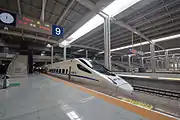 CRH5A bound for Lanzhou Zhongchuan Airport railway station at platform level