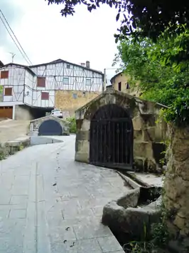 A village medieval street with traditional houses at the background