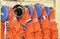 ACES suits on coat hanger, NASA
