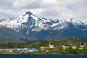 Lax Kwʼalaams backdropped by Mount McNeil of the Kitimat Ranges