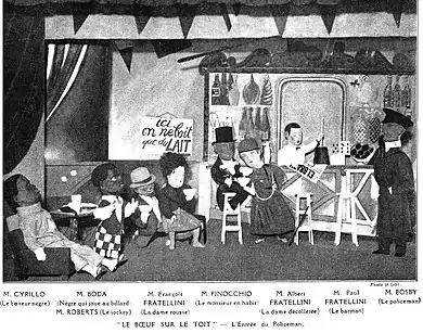 stage scene in a bar with characters wearing large cardboard heads