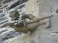 One of the unusual gargoyles decorating the church. A cavalier draws his sword.