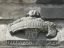 In this carving on the chevet an angel holds a phylactery