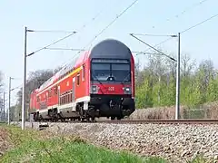 Modernized double-decker train of S1 with a 1992 control car in April 2010 between Leipzig-Leutzsch and Leipzig-Möckern in typical "DB-red" now