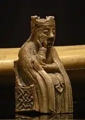 Photograph of an ivory gaming piece depicting a seated queen