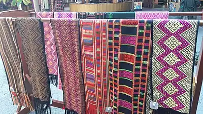 Traditional Hlai narrow cloth brocades are woven on a bamboo backstrap loom braced with the feet