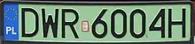 A rectangular plate with green background reading DWR6004H