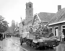 The Royal Hamilton Light Infantry Carrier move through the Dutch village of Krabbendijke on the Beveland Causeway, 27 October 1944