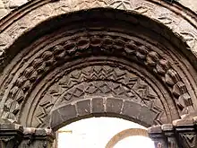 Arch and tympanum over the processional entrance on south side of the church.