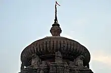 sculpture of lion projecting from the main spire of the temple