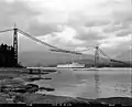 Lions Gate Bridge under construction with Empress of Japan II passing underneath. 1938.