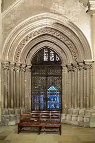 Romanesque door and iron gate leading to the ambulatory.