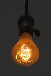 An incandescent light bulb's filament emitting light