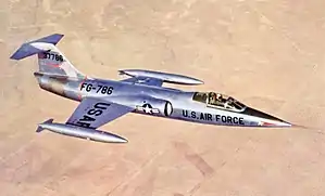 XF-104 prototype in flight over desert
