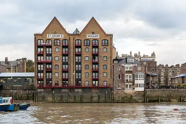 Wapping: warehouses — now flats and a pub — built on the wall