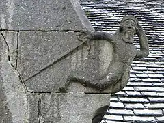 Unusual carving on church exterior at Loqueffret