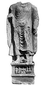 Statue with inscription mentioning "year 318", probably 143 AD. The two devotees on the right side of the pedestal are in Indo-Scythian suit (loose trousers, tunic, and hood).
