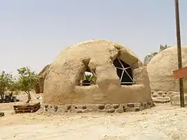 A dome house in Lotan, made of straw bales covered with earth plaster