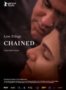 Chained film poster - showing a dark-haired woman's profile, with her eyes closed, and a man next to her, his head touching hers