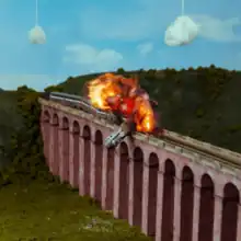 A still of an animated train derailing and exploding on a bridge, with two clouds in the background hanging from strings